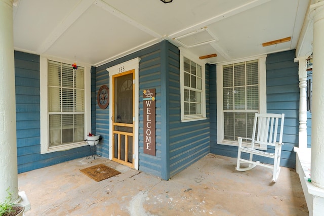 view of exterior entry with a porch