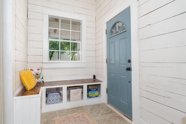 mudroom featuring wood walls