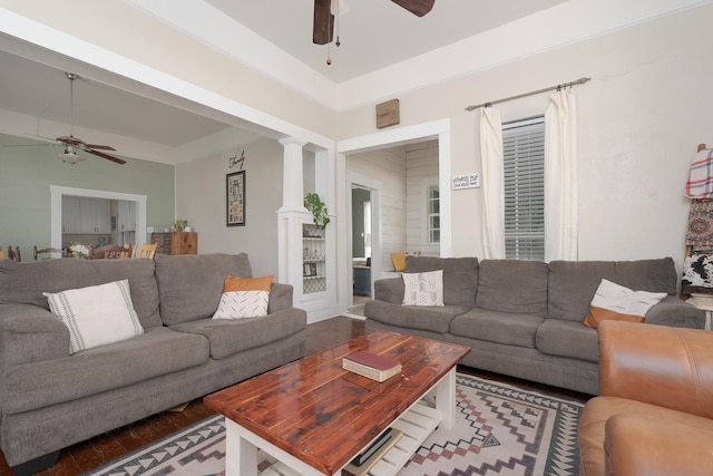 living room featuring wood finished floors, ceiling fan, and decorative columns