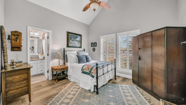 bedroom with connected bathroom, ceiling fan, light wood-type flooring, and high vaulted ceiling