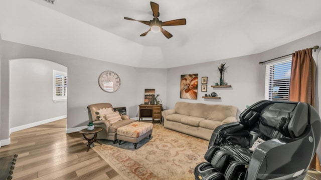 living area with wood finished floors, ceiling fan, and baseboards