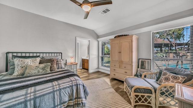 bedroom with visible vents, baseboards, light wood-type flooring, vaulted ceiling, and a ceiling fan