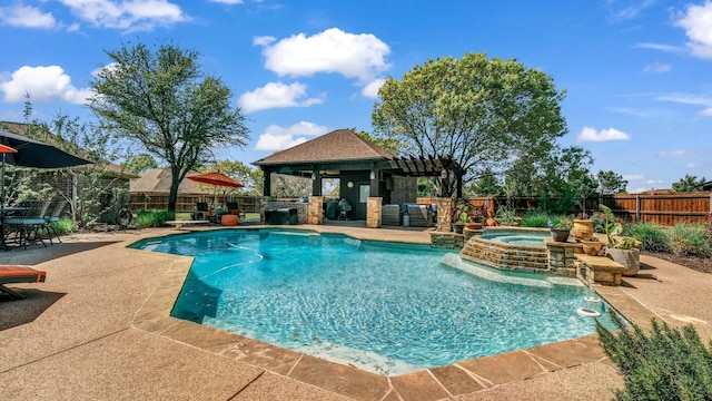 view of pool with a pool with connected hot tub, a gazebo, a patio, and a fenced backyard