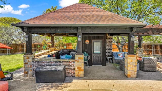 view of patio featuring a gazebo, outdoor dry bar, and a fenced backyard
