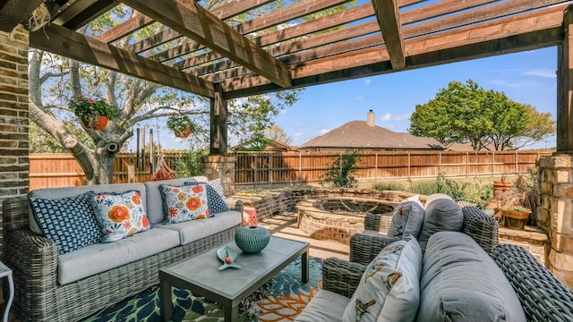 view of patio with an outdoor living space with a fire pit, a pergola, and a fenced backyard