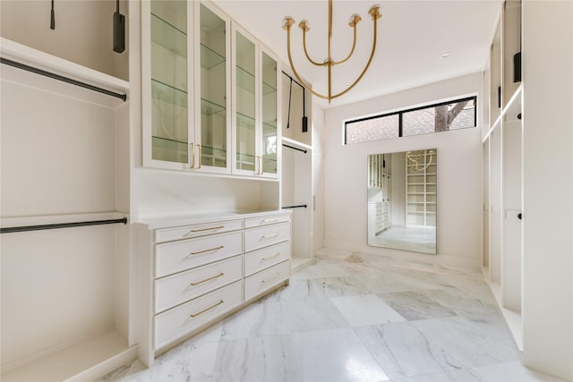 6814 Glendora Ave, Dallas, TX 75230 - spacious closet with a chandelier and light marble finish floors