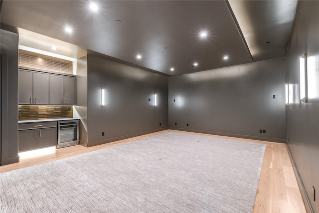 6814 Glendora Ave, Dallas, TX 75230 - unfurnished living room with wine cooler, light wood-style floors, bar with sink, baseboards, and recessed lighting