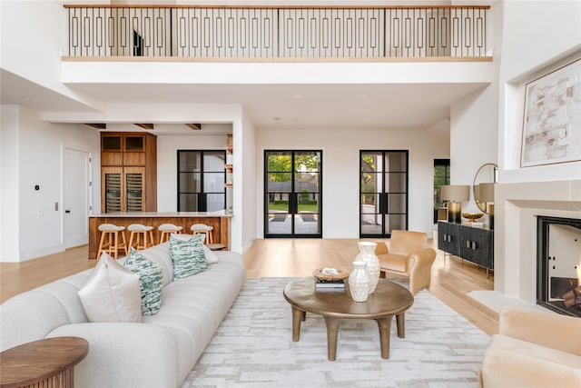 6814 Glendora Ave, Dallas, TX 75230 - living area with light wood-style floors, a high ceiling, and baseboards