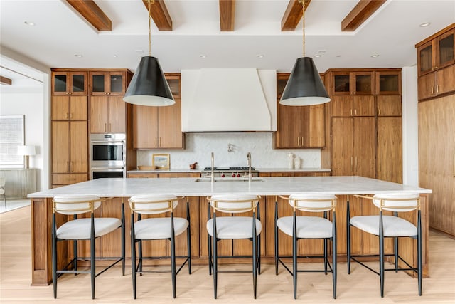 6814 Glendora Ave, Dallas, TX 75230 - kitchen featuring double oven, extractor fan, a sink, tasteful backsplash, and beam ceiling