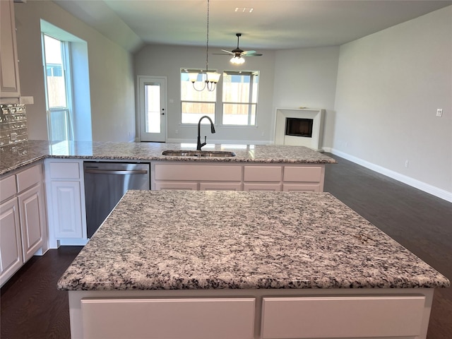 39 Magpie, Joshua, TX 76058 - kitchen with stainless steel dishwasher, light stone countertops, white cabinets, a ceiling fan, and lofted ceiling