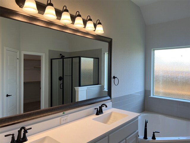 39 Magpie, Joshua, TX 76058 - full bathroom with a stall shower, double vanity, a walk in closet, a bath, and vaulted ceiling