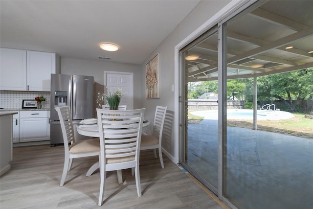 dining room featuring visible vents and light wood finished floors