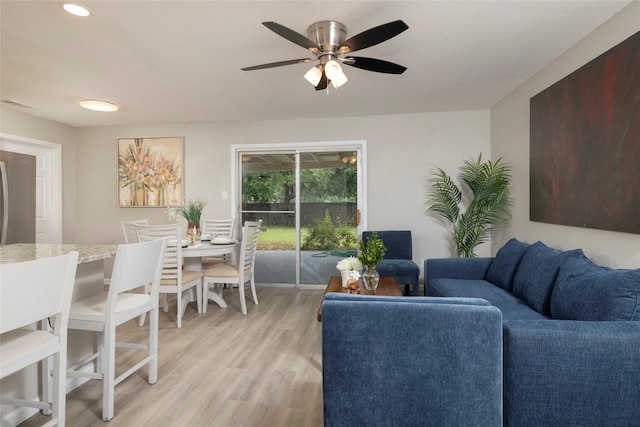 living room with a ceiling fan, recessed lighting, and light wood finished floors