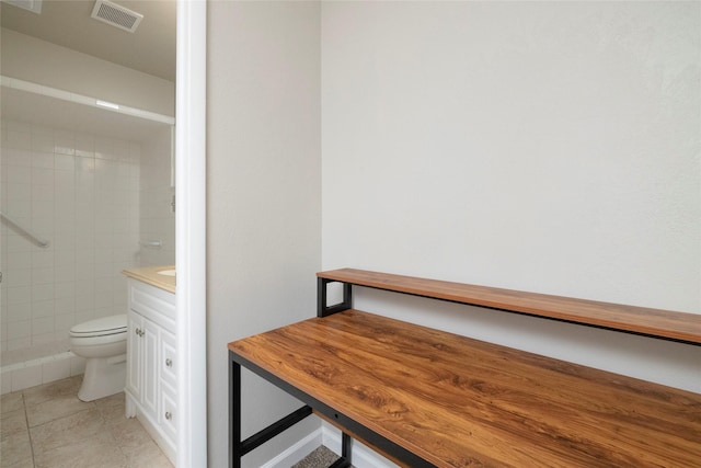 full bathroom with visible vents, vanity, tile patterned floors, toilet, and tiled shower