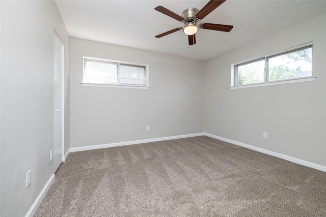 unfurnished room featuring baseboards, carpet flooring, and a ceiling fan