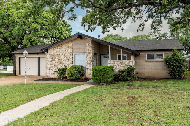view of front of home featuring a garage, concrete driveway, a front lawn, and stone siding