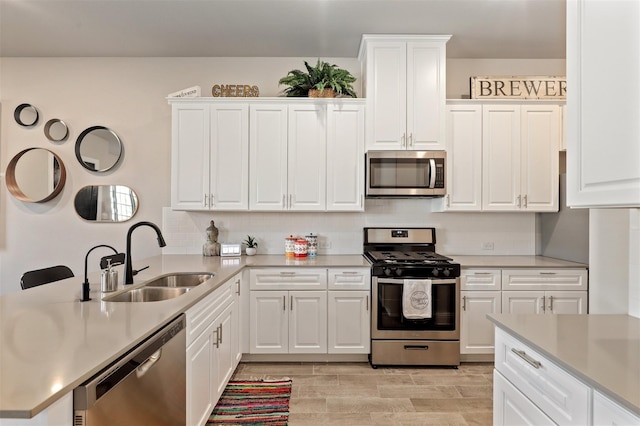 6246 Rilla St, Frisco, TX 75035 - kitchen featuring a peninsula, appliances with stainless steel finishes, light countertops, and a sink