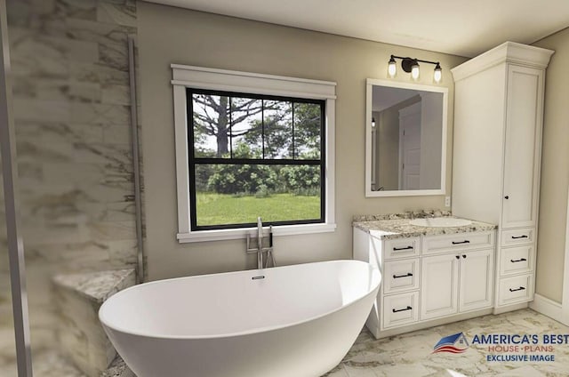 bathroom featuring marble finish floor, a freestanding tub, and vanity