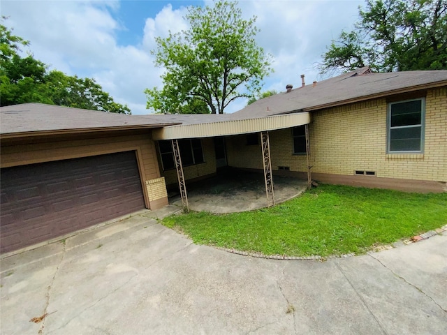 ranch-style home featuring concrete driveway, a garage, and brick siding