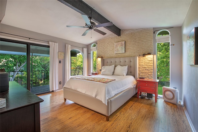 bedroom with vaulted ceiling with beams, baseboards, wood finished floors, and access to exterior