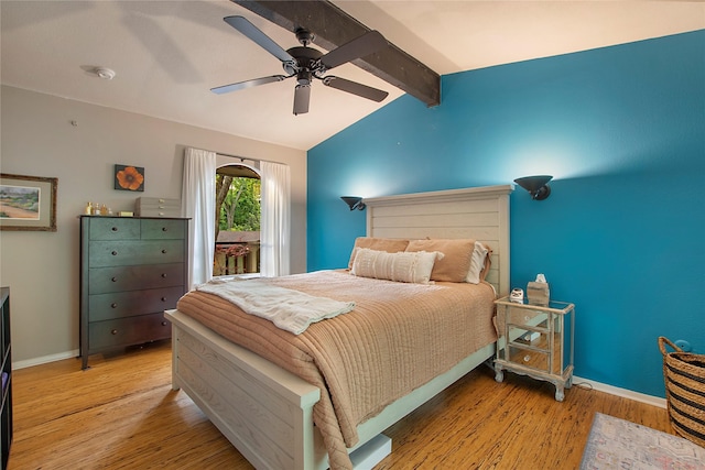 bedroom with baseboards, lofted ceiling with beams, light wood-style flooring, and ceiling fan