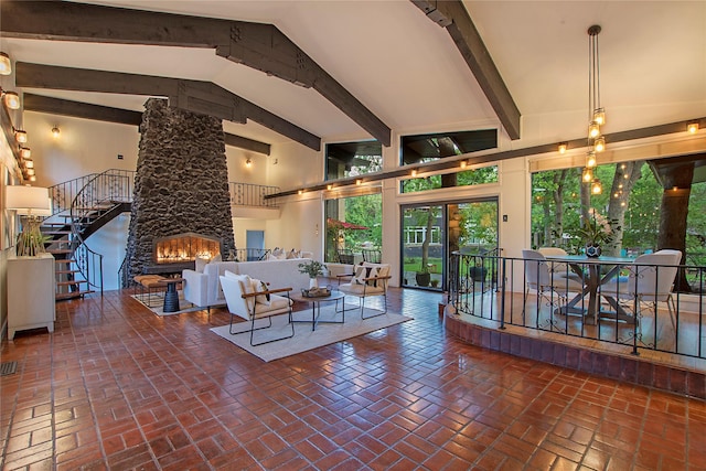 living area with high vaulted ceiling, brick floor, a fireplace, and beamed ceiling