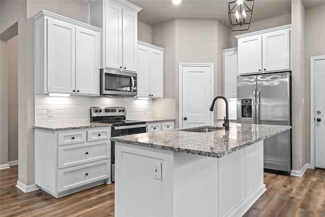 kitchen featuring stainless steel appliances, white cabinets, dark wood-style floors, and baseboards