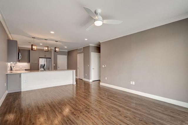 unfurnished living room featuring recessed lighting, ornamental molding, ceiling fan, baseboards, and dark wood-style floors