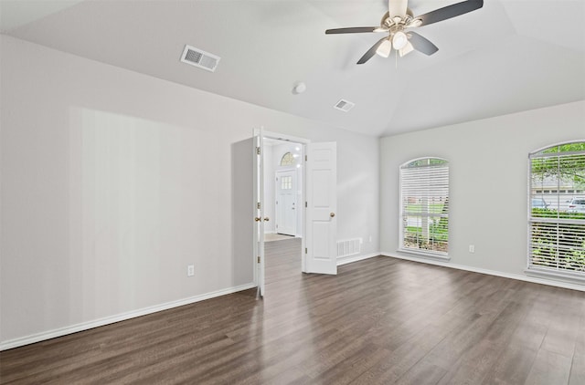 empty room featuring visible vents, dark wood-type flooring, and ceiling fan