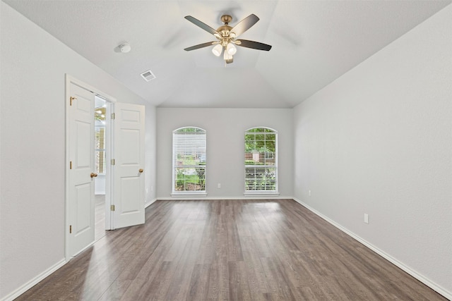 empty room featuring baseboards, a ceiling fan, dark wood-style floors, and visible vents