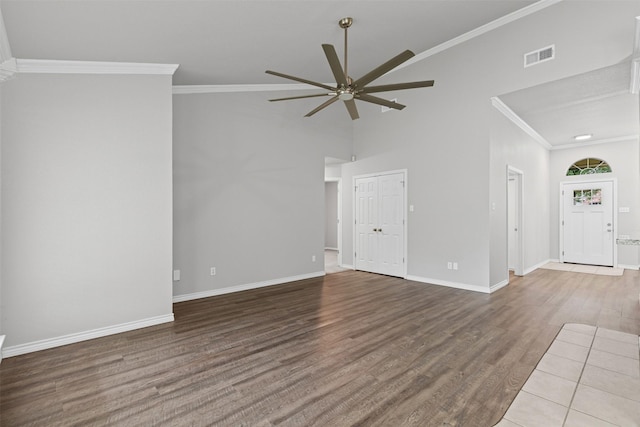 unfurnished living room featuring crown molding, baseboards, ceiling fan, and wood finished floors