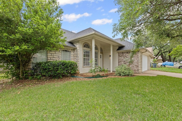 ranch-style home featuring concrete driveway, roof with shingles, an attached garage, and a front yard