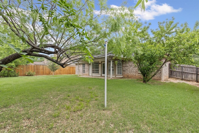 view of yard with a fenced backyard