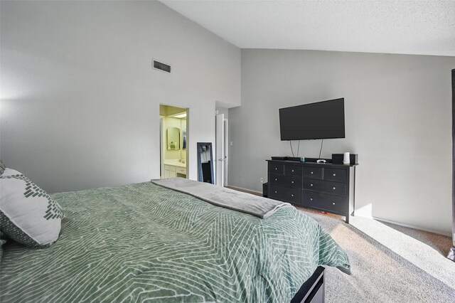 bedroom with visible vents, high vaulted ceiling, carpet, and ensuite bath