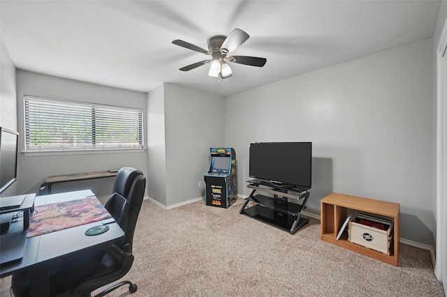 office space with ceiling fan, baseboards, and carpet floors