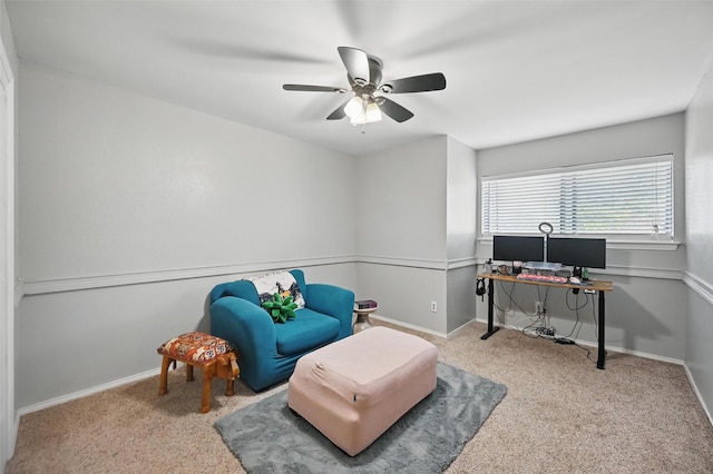sitting room featuring a ceiling fan, baseboards, and carpet floors