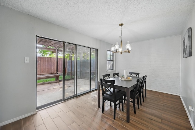 dining space with wood finished floors, a chandelier, and plenty of natural light