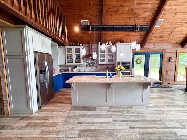 11300 Massey Rd, Pilot Point, TX 76258 - kitchen with appliances with stainless steel finishes, wooden ceiling, decorative backsplash, a center island with sink, and a breakfast bar area