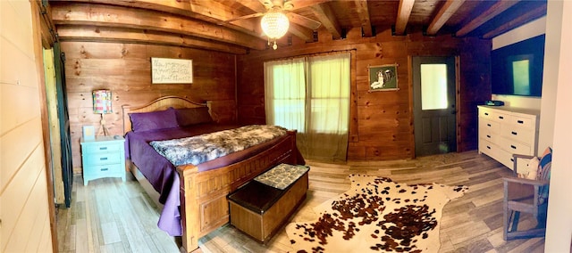 11300 Massey Rd, Pilot Point, TX 76258 - bedroom with light wood-type flooring, wooden walls, beamed ceiling, and wood ceiling