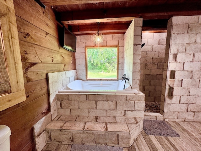 11300 Massey Rd, Pilot Point, TX 76258 - bathroom featuring a garden tub, walk in shower, wood walls, and wood finished floors