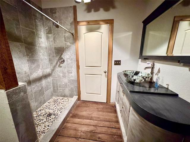 11300 Massey Rd, Pilot Point, TX 76258 - full bath with hardwood / wood-style floors, tiled shower, and vanity