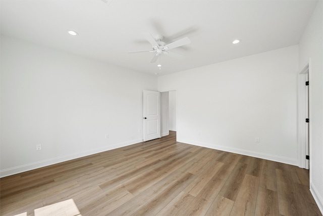 spare room featuring baseboards, recessed lighting, wood finished floors, and ceiling fan