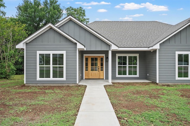 view of front of property featuring board and batten siding and a shingled roof