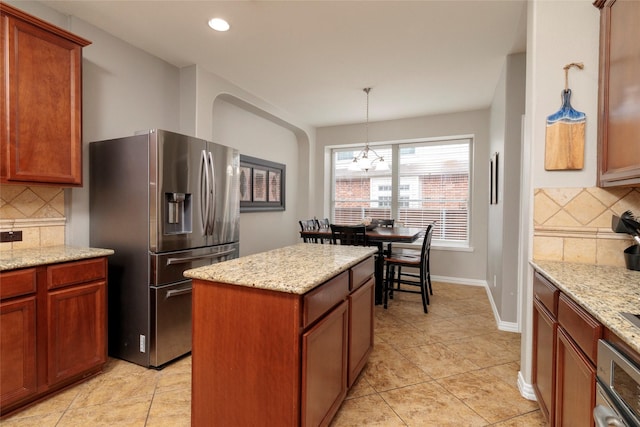 4953 Van Zandt Dr, Fort Worth, TX 76244 - kitchen featuring a center island, pendant lighting, stainless steel fridge with ice dispenser, and decorative backsplash