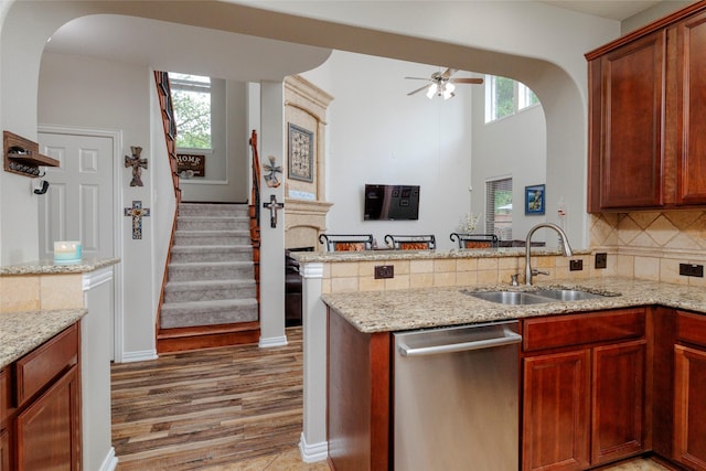 4953 Van Zandt Dr, Fort Worth, TX 76244 - kitchen featuring decorative backsplash, ceiling fan, dishwasher, a sink, and a peninsula