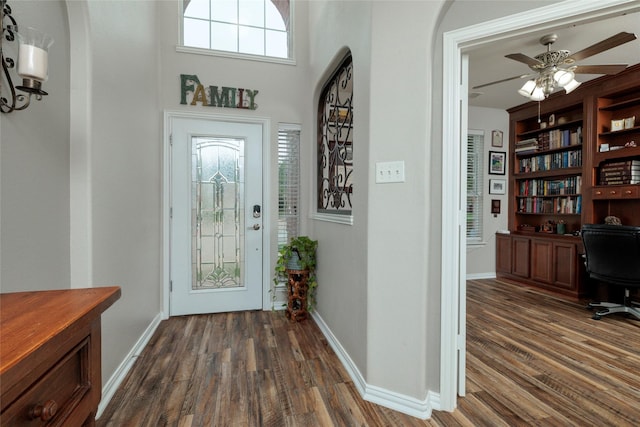 4953 Van Zandt Dr, Fort Worth, TX 76244 - foyer entrance with dark wood-style floors, arched walkways, ceiling fan, and baseboards
