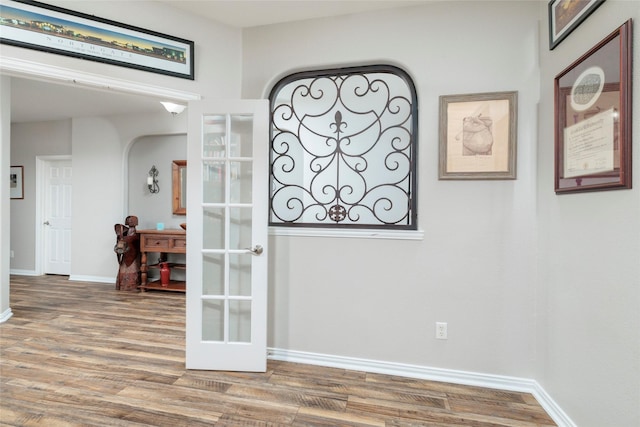 4953 Van Zandt Dr, Fort Worth, TX 76244 - spare room featuring arched walkways, wood finished floors, and baseboards