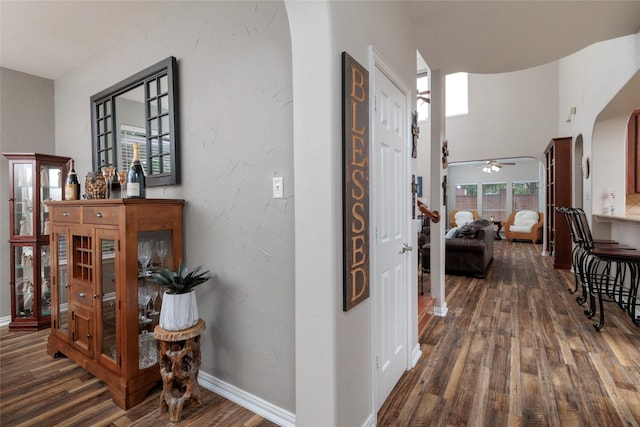 4953 Van Zandt Dr, Fort Worth, TX 76244 - corridor featuring baseboards, arched walkways, and dark wood-type flooring