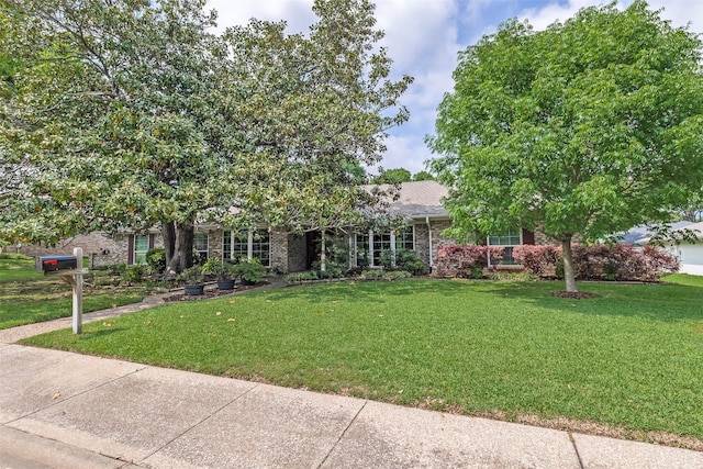 7215 Hillwood Ln, Dallas, TX 75248 - view of front of home featuring brick siding, a front lawn, and roof with shingles