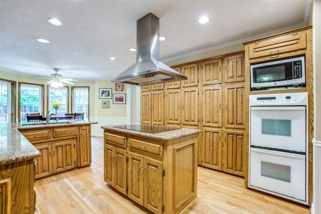 7215 Hillwood Ln, Dallas, TX 75248 - kitchen featuring white double oven, island range hood, stainless steel microwave, black electric cooktop, and a center island